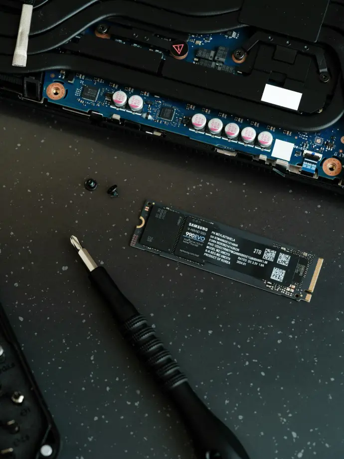 A close up of a motherboard and a pen on a table
